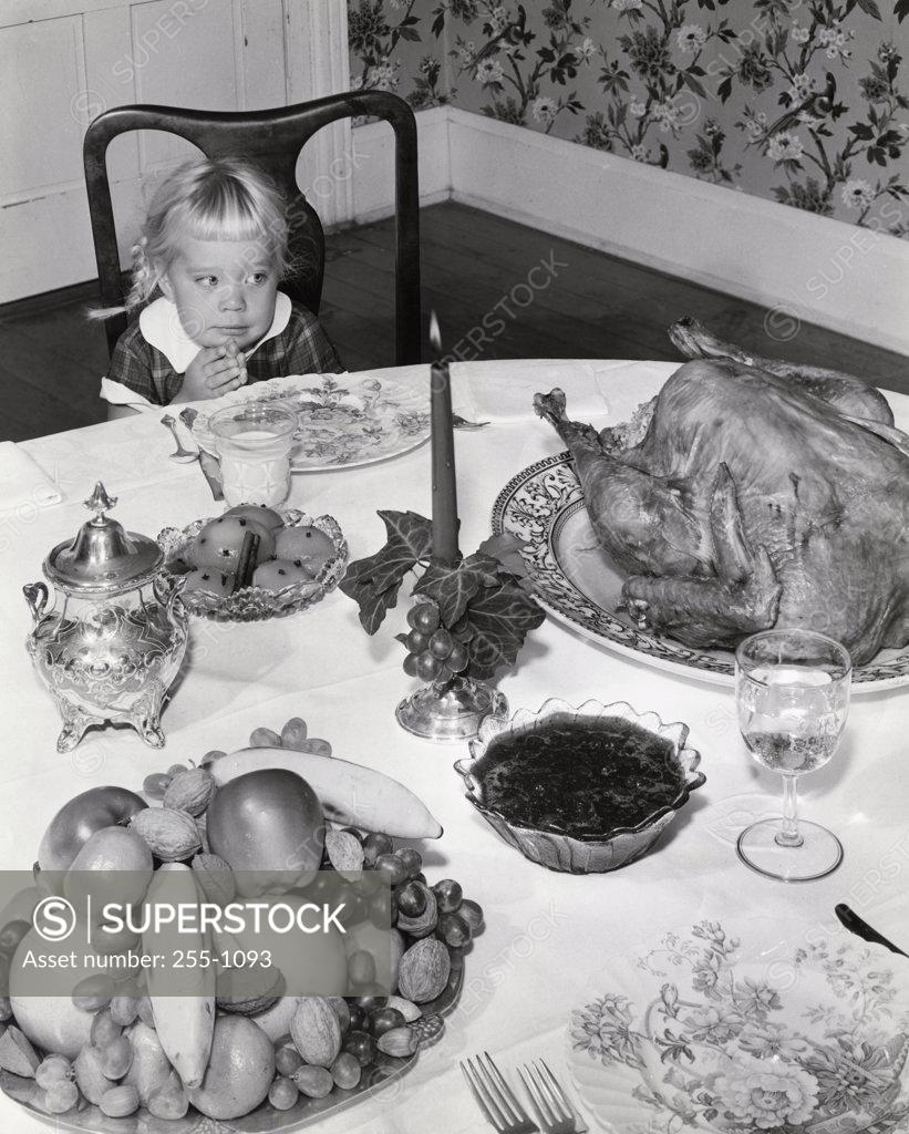 Stock Photo: 255-1093 Little girl looking at Thankgsgiving Turkey
