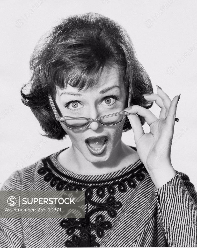 Stock Photo: 255-10971 Studio portrait of young woman looking surprised