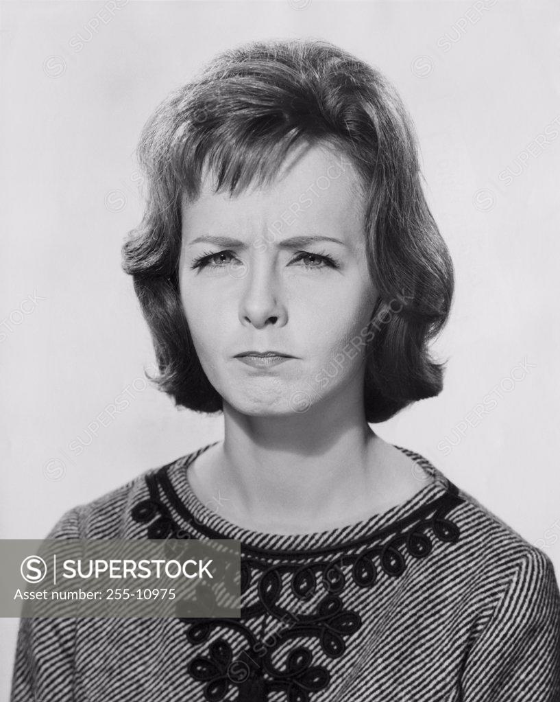 Stock Photo: 255-10975 Portrait of a young woman frowning