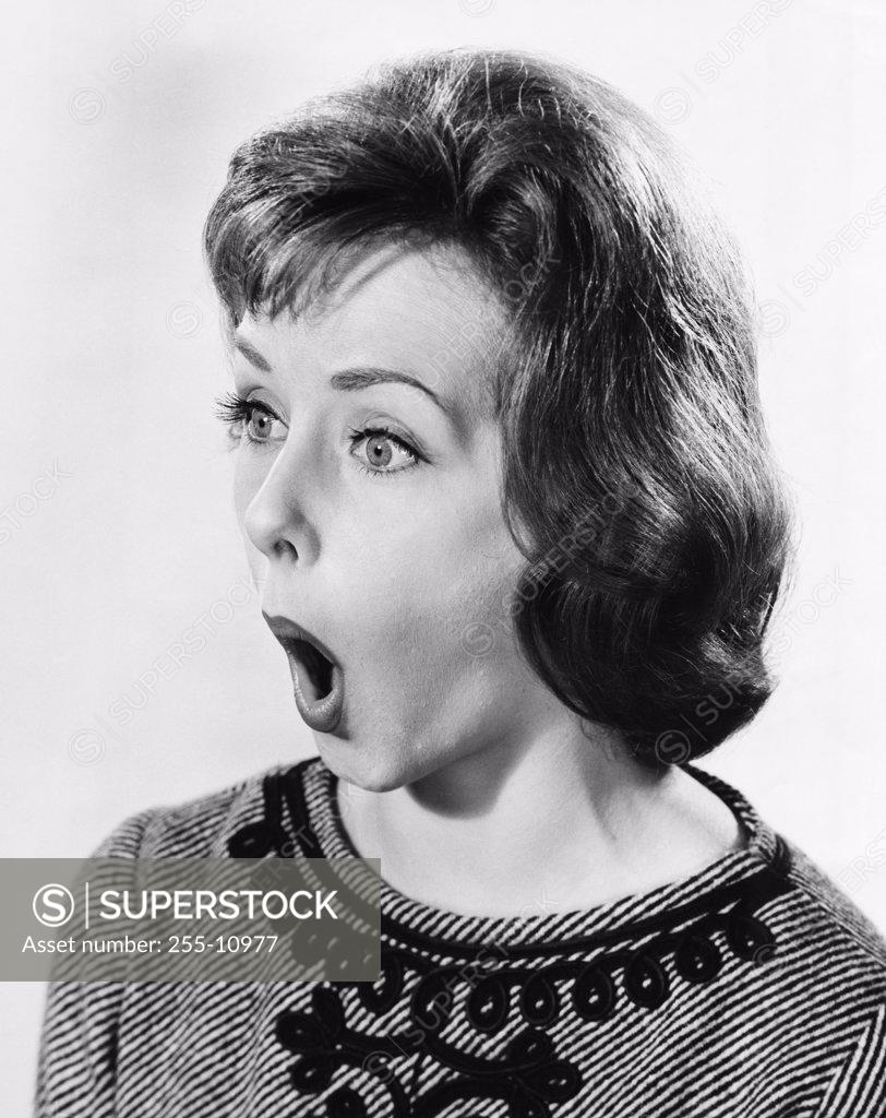Stock Photo: 255-10977 Young woman looking surprised