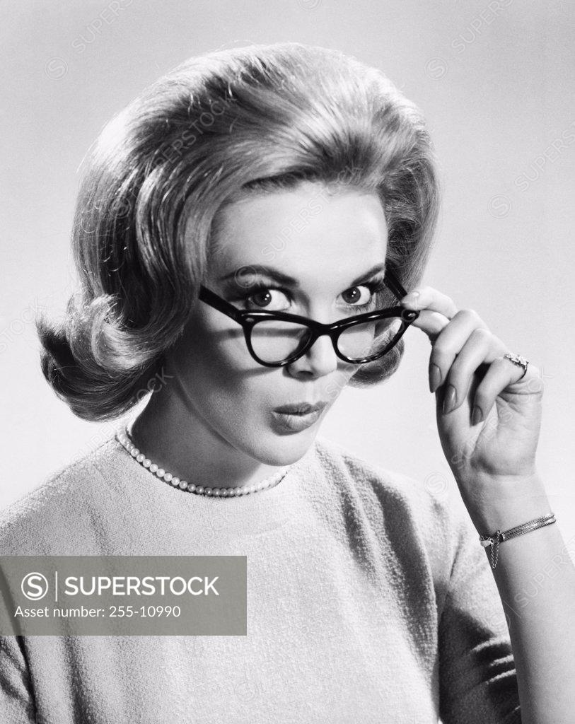Stock Photo: 255-10990 Close-up of a young woman holding eyeglasses