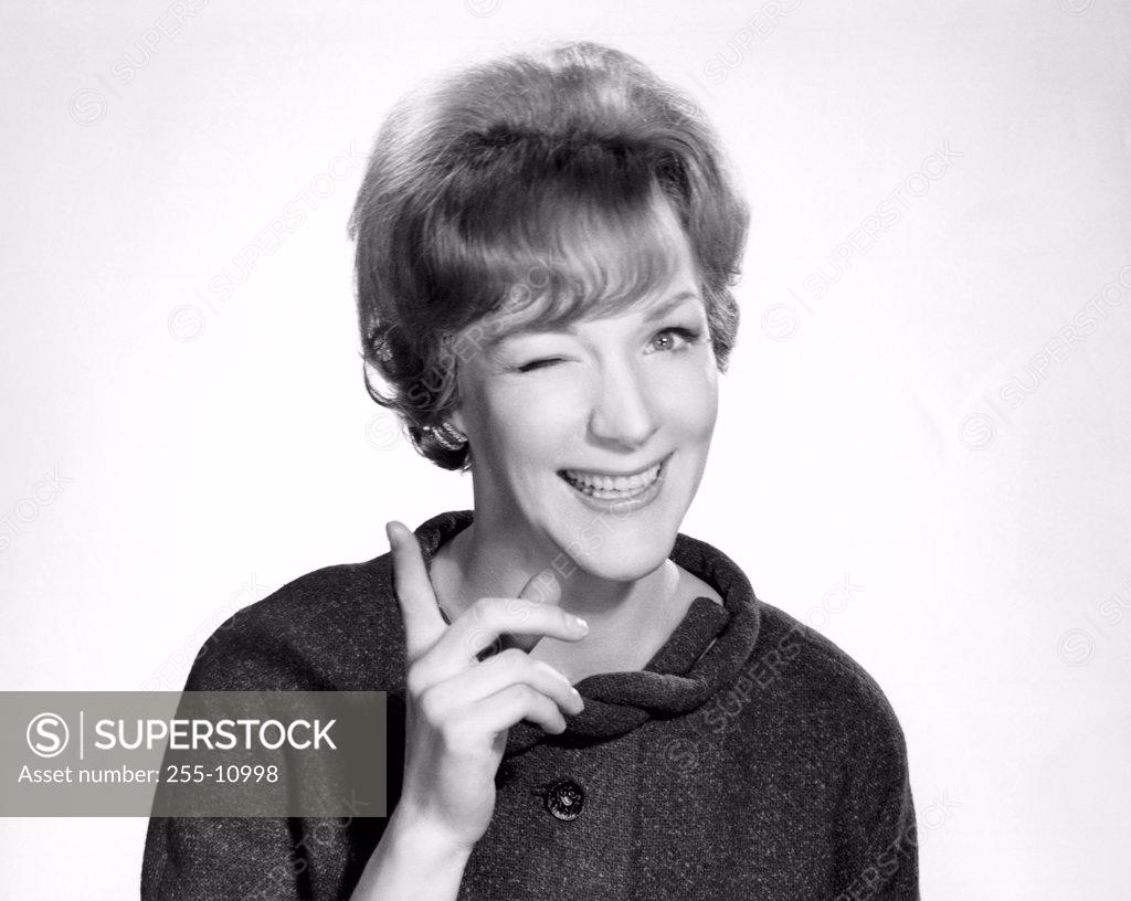 Stock Photo: 255-10998 Portrait of a young woman winking