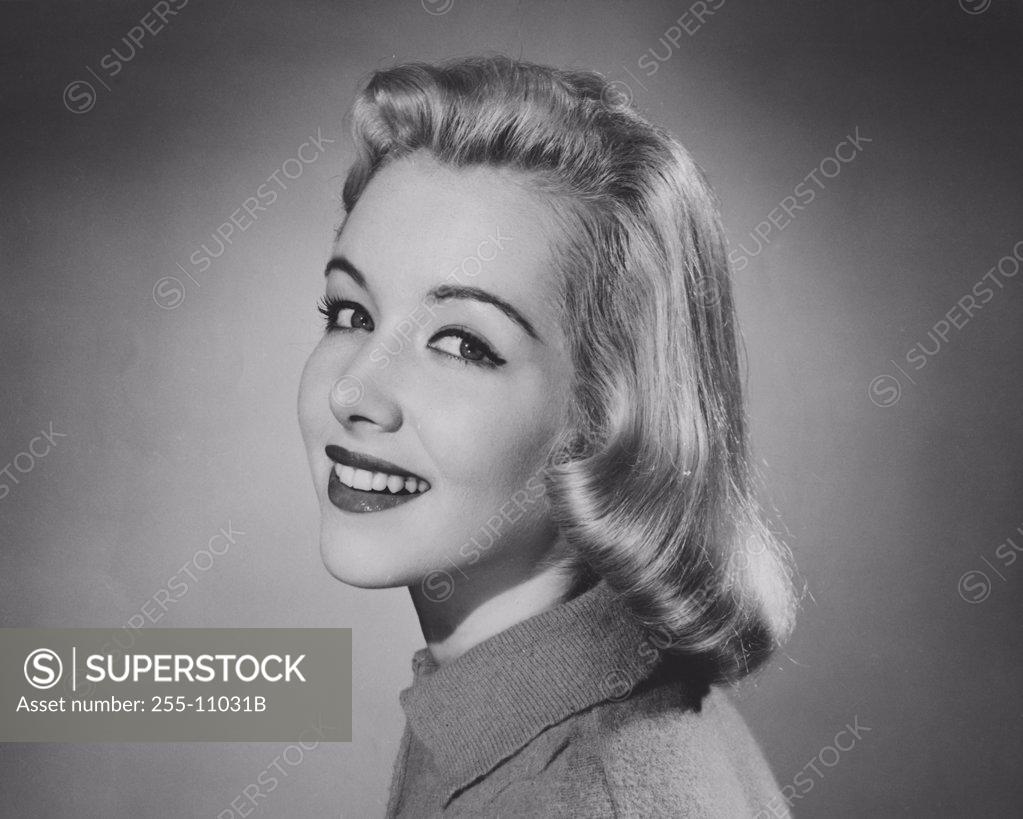 Stock Photo: 255-11031B Studio portrait of young woman smiling