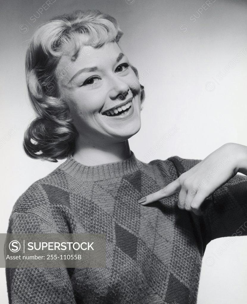 Stock Photo: 255-11055B Portrait of a young woman pointing to herself