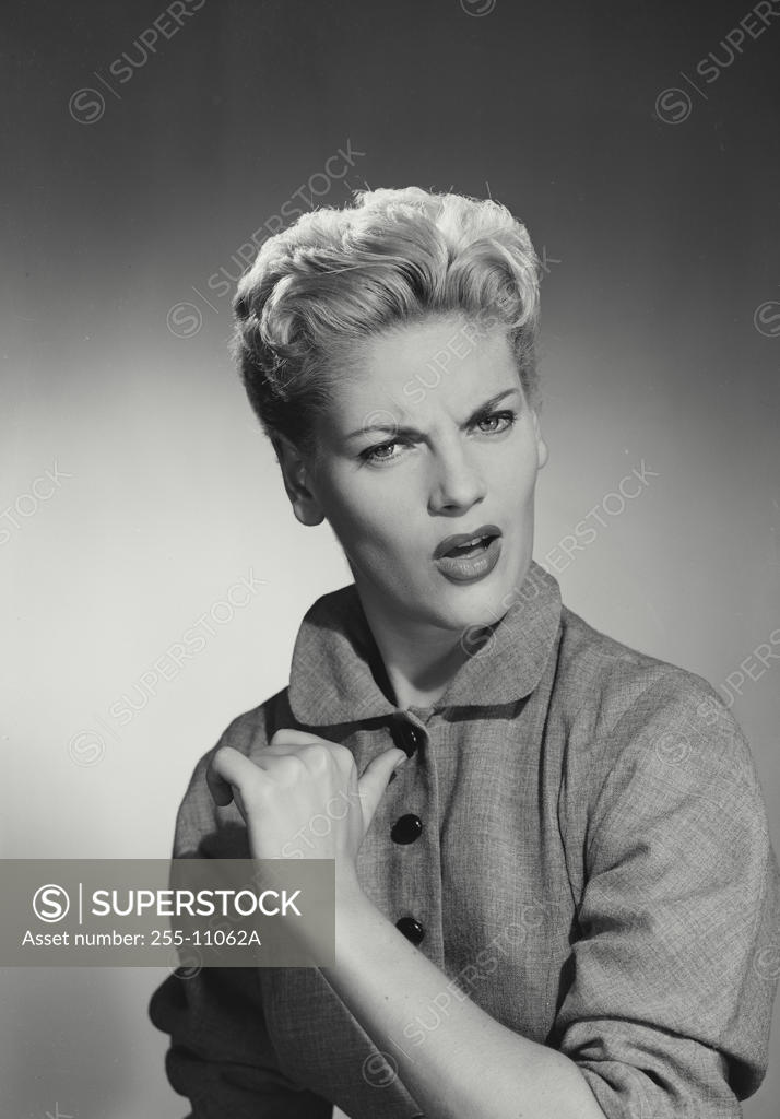 Stock Photo: 255-11062A Studio portrait of young woman frowning