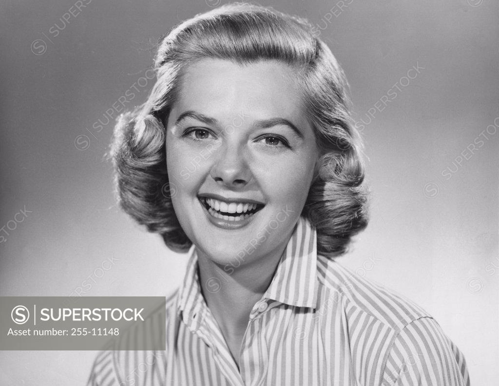 Stock Photo: 255-11148 Studio portrait of young woman smiling