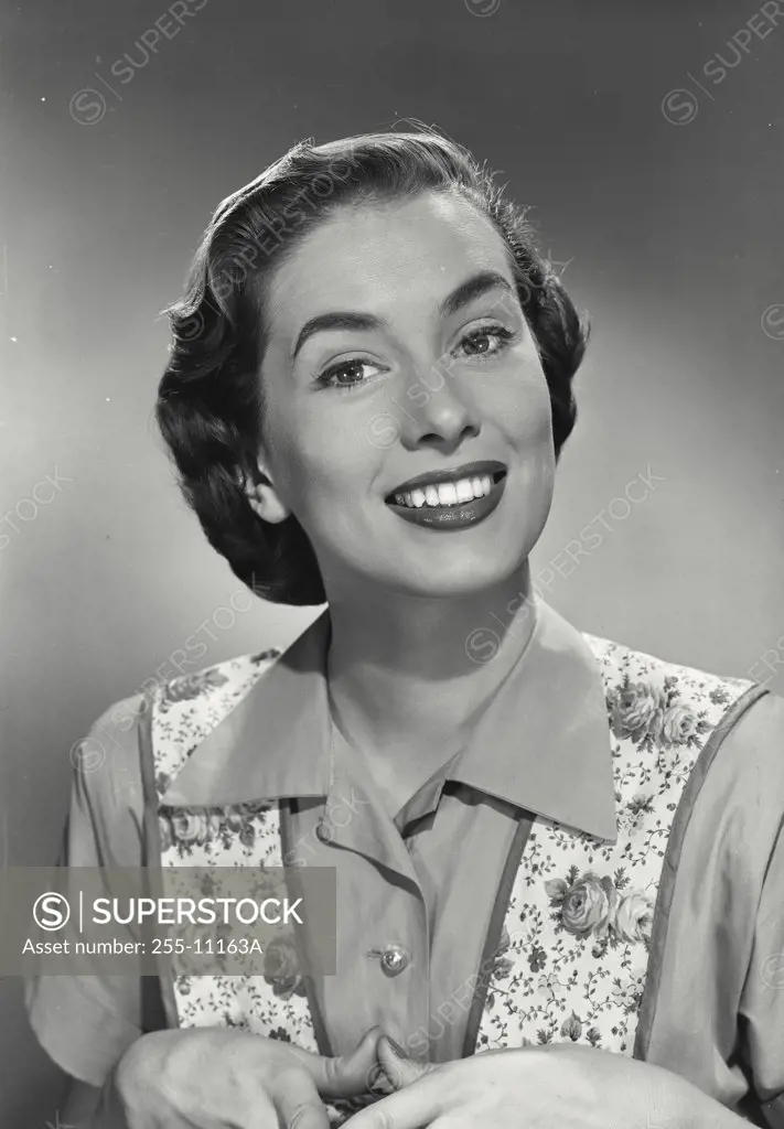 Portrait of brunette woman wearing flowery vest smiling