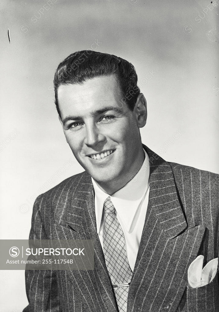 Stock Photo: 255-11754B Studio portrait of businessman smiling