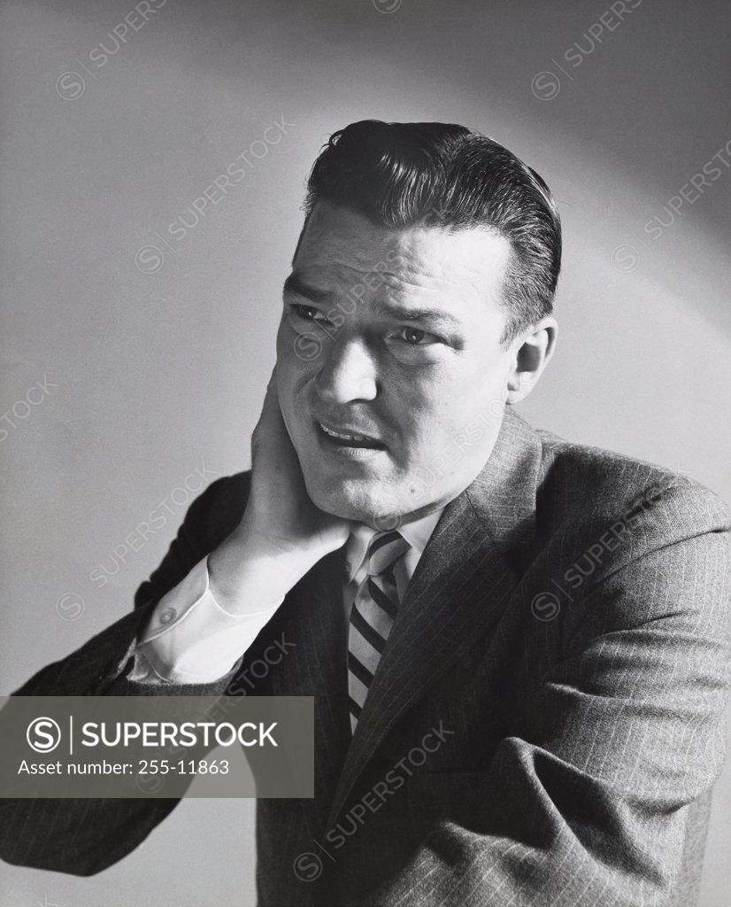 Stock Photo: 255-11863 Close-up of a businessman suffering from a neck pain
