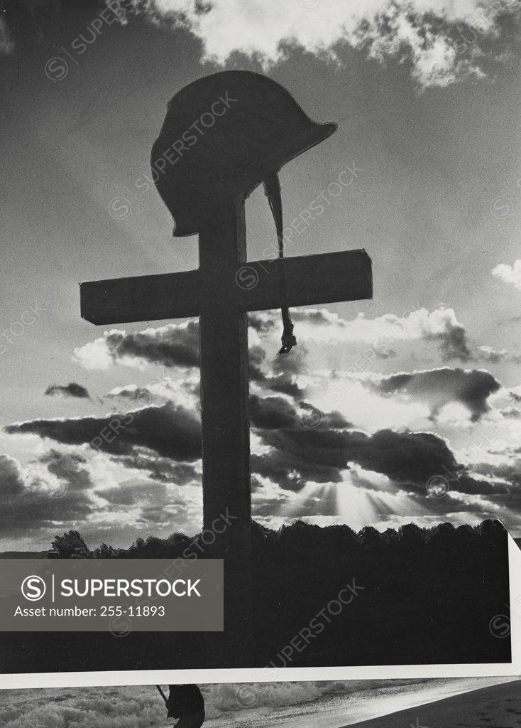Stock Photo: 255-11893 Low angle view of a helmet on a cross