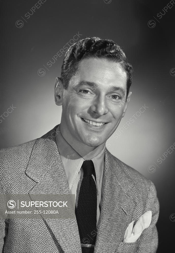 Stock Photo: 255-12080A Studio portrait of businessman smiling