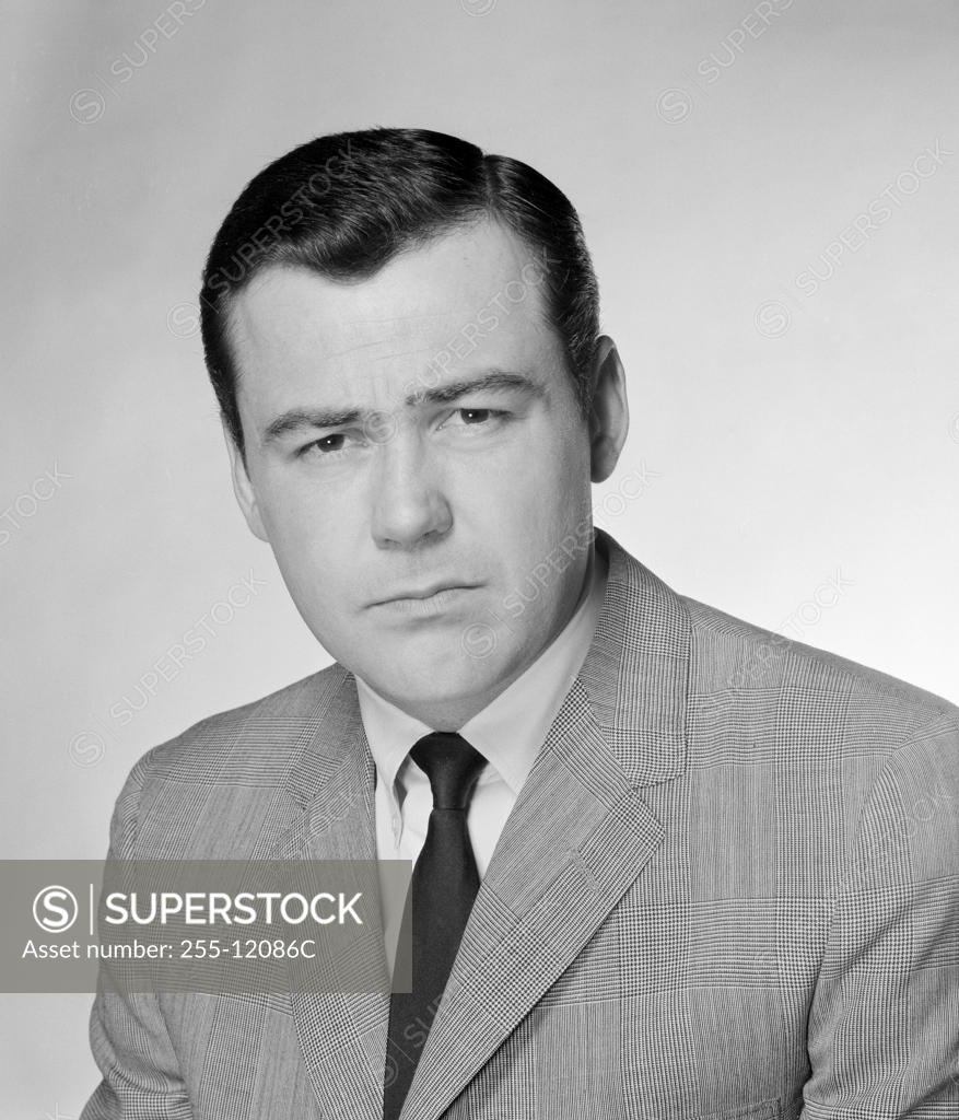 Stock Photo: 255-12086C Studio portrait of serious businessman
