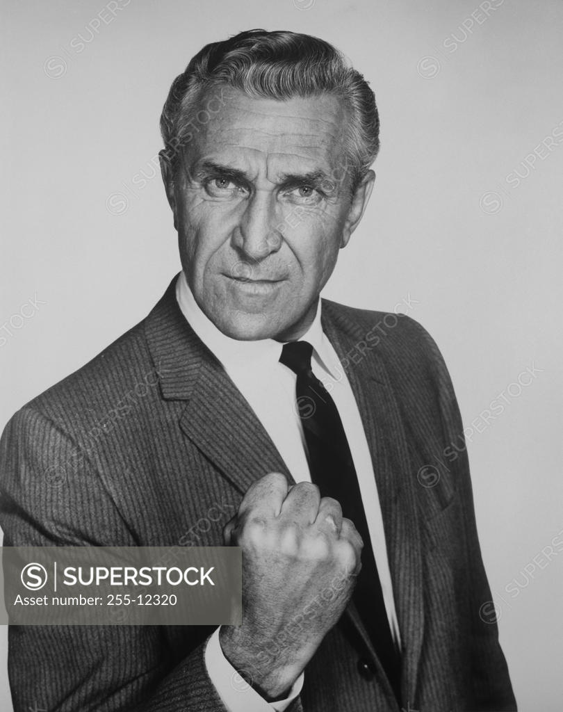Stock Photo: 255-12320 Portrait of a senior man showing his fist