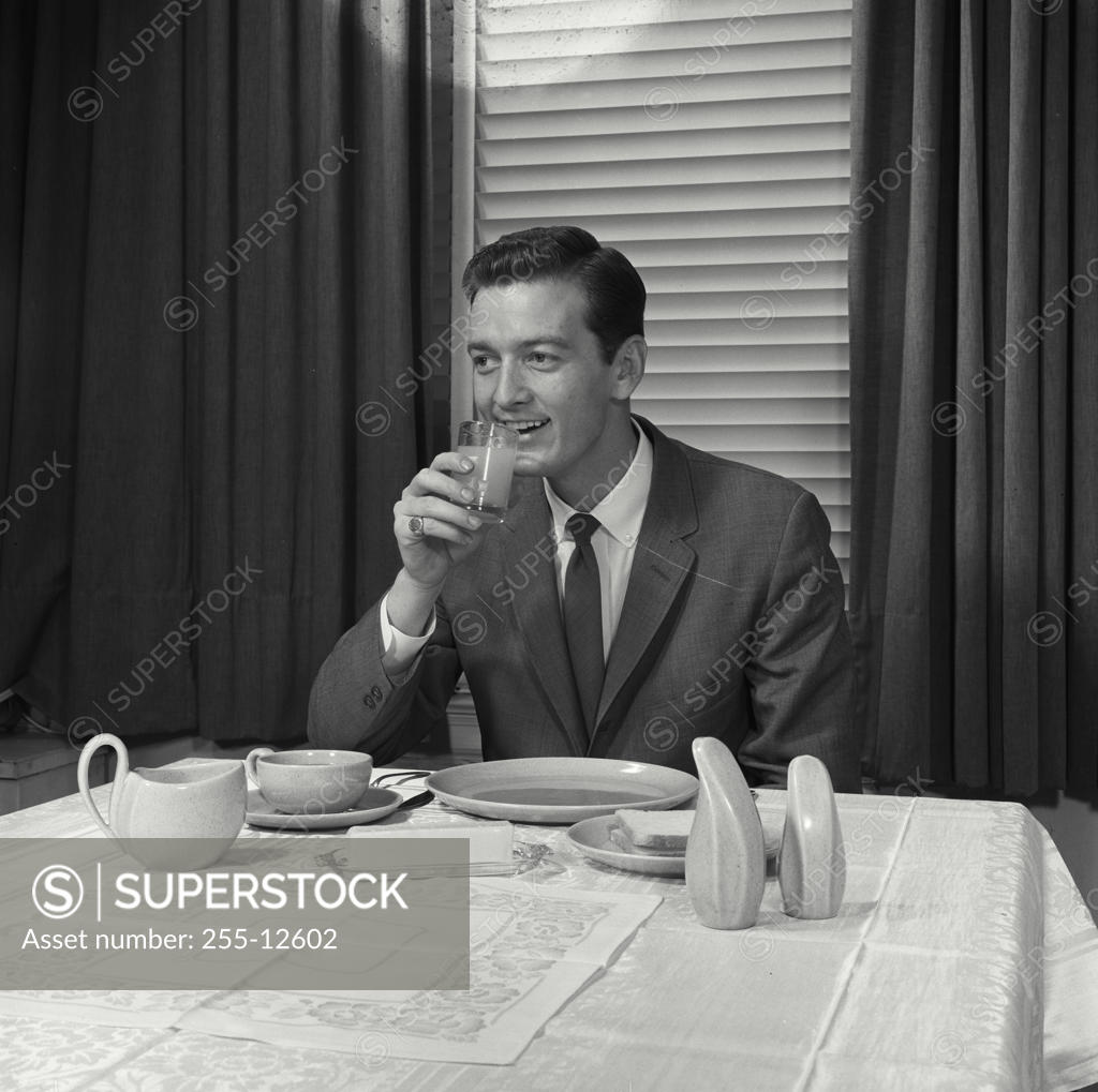 Stock Photo: 255-12602 Close-up of a mid adult man drinking juice