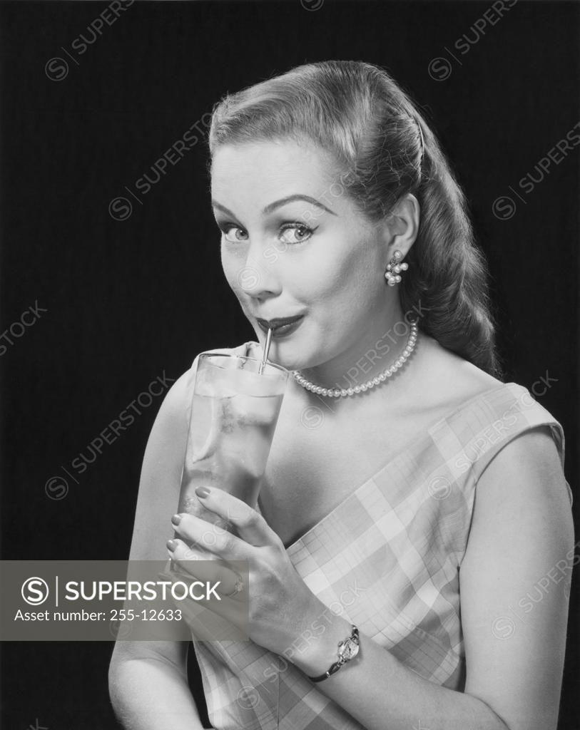 Stock Photo: 255-12633 Portrait of a young woman drinking