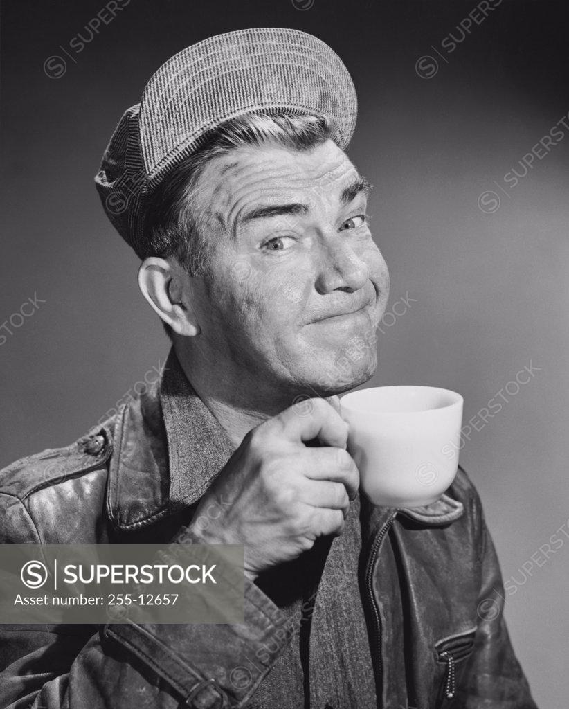 Stock Photo: 255-12657 Portrait of a mature man drinking from a tea cup