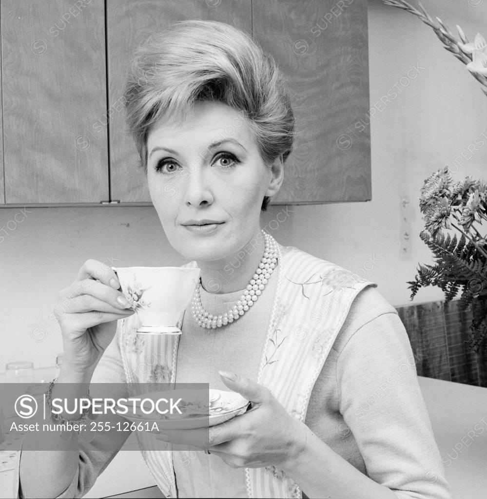 Stock Photo: 255-12661A Portrait of a mature woman holding a tea cup