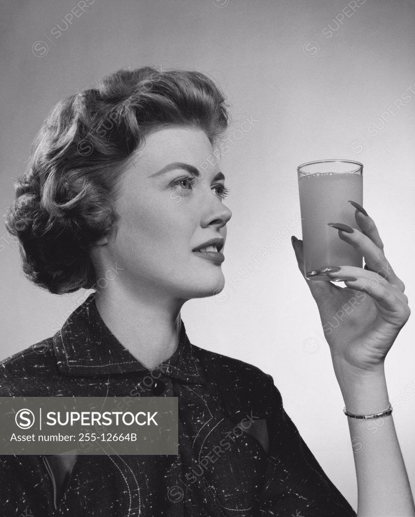 Stock Photo: 255-12664B Close-up of a young woman holding a glass of juice