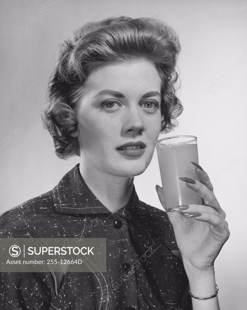 Stock Photo: 255-12664D Portrait of a young woman holding a glass of juice