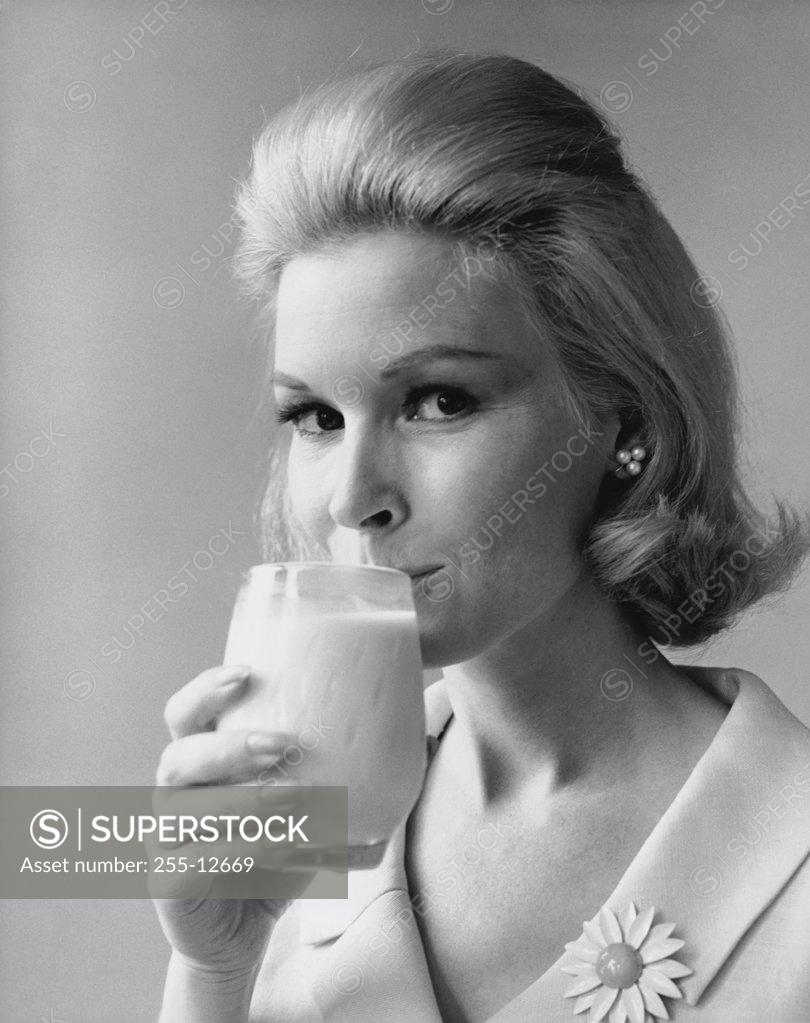 Stock Photo: 255-12669 Portrait of a young woman drinking milk