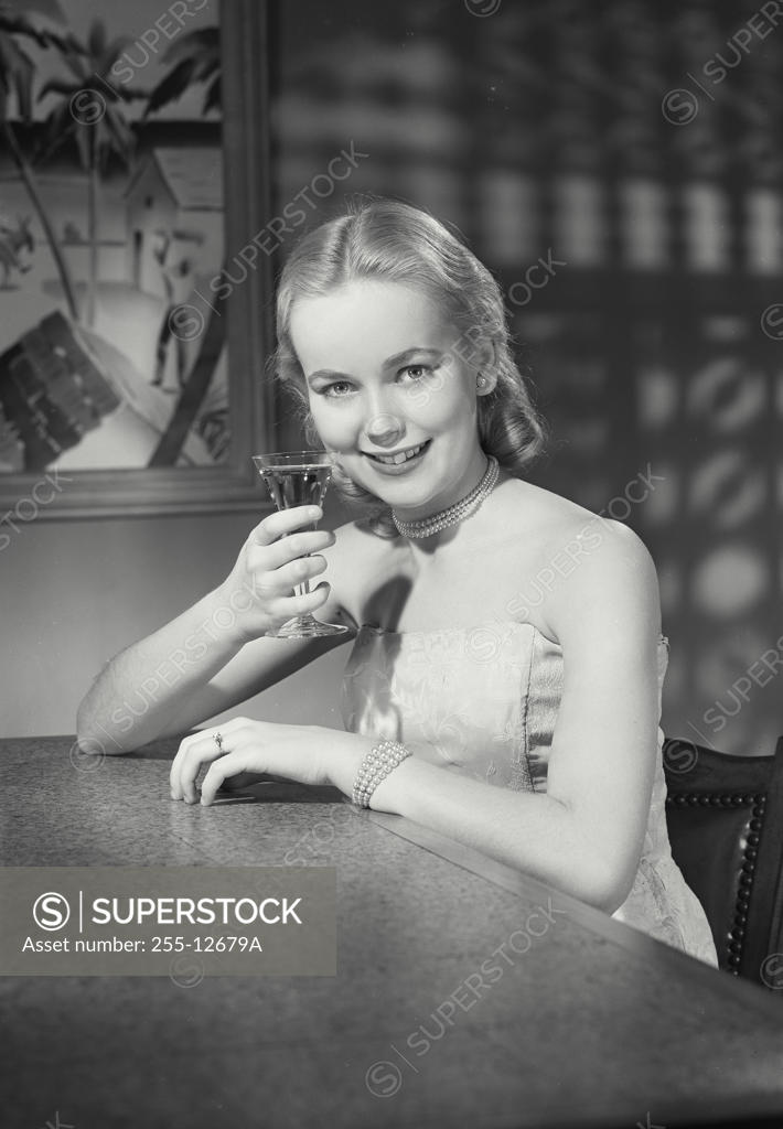 Stock Photo: 255-12679A Portrait of a young woman drinking a martini