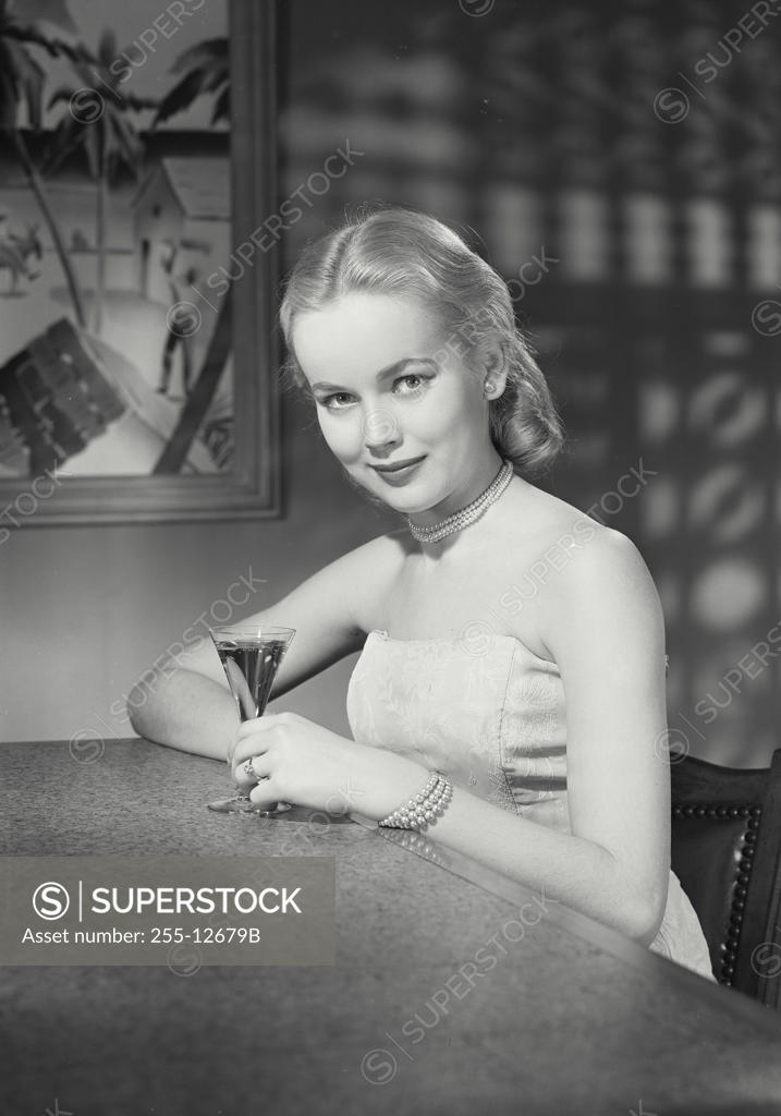 Stock Photo: 255-12679B Portrait of a young woman holding a martini