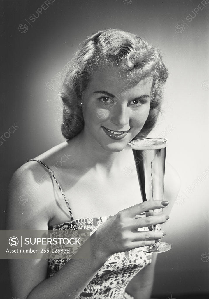 Stock Photo: 255-12683B Portrait of a young woman holding a glass of beer