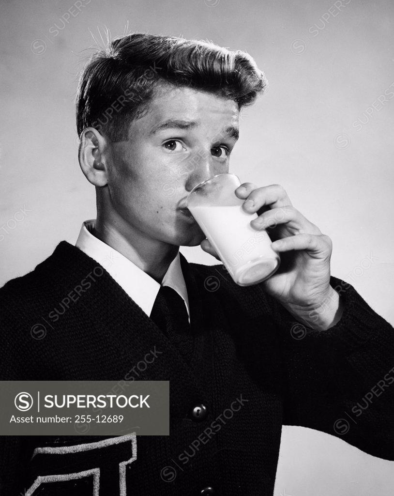 Stock Photo: 255-12689 Portrait of a young man drinking milk