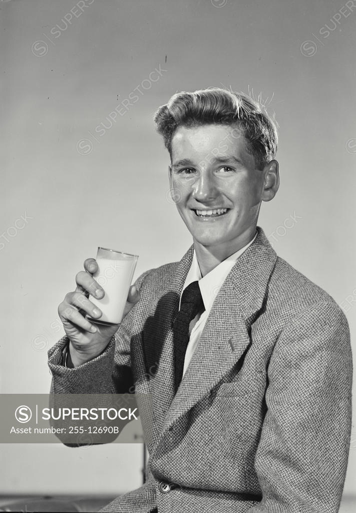 Stock Photo: 255-12690B Portrait of a young man holding a glass of milk