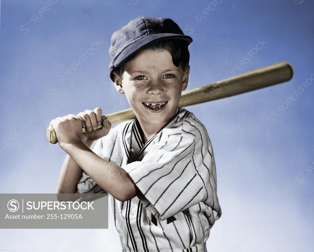 Stock Photo: 255-12905A Portrait of boy swinging baseball bat