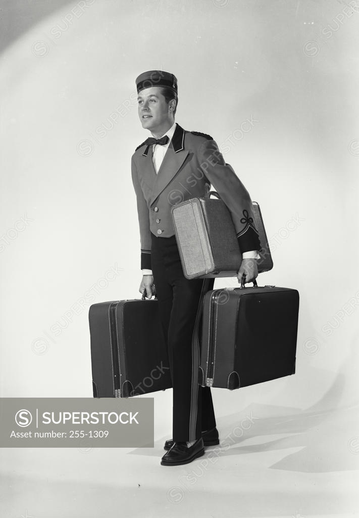 Stock Photo: 255-1309 Bellhop carrying luggage