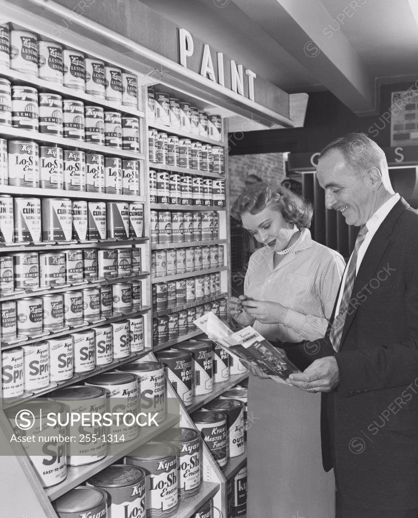 Stock Photo: 255-1314 Mature couple standing in a paint store