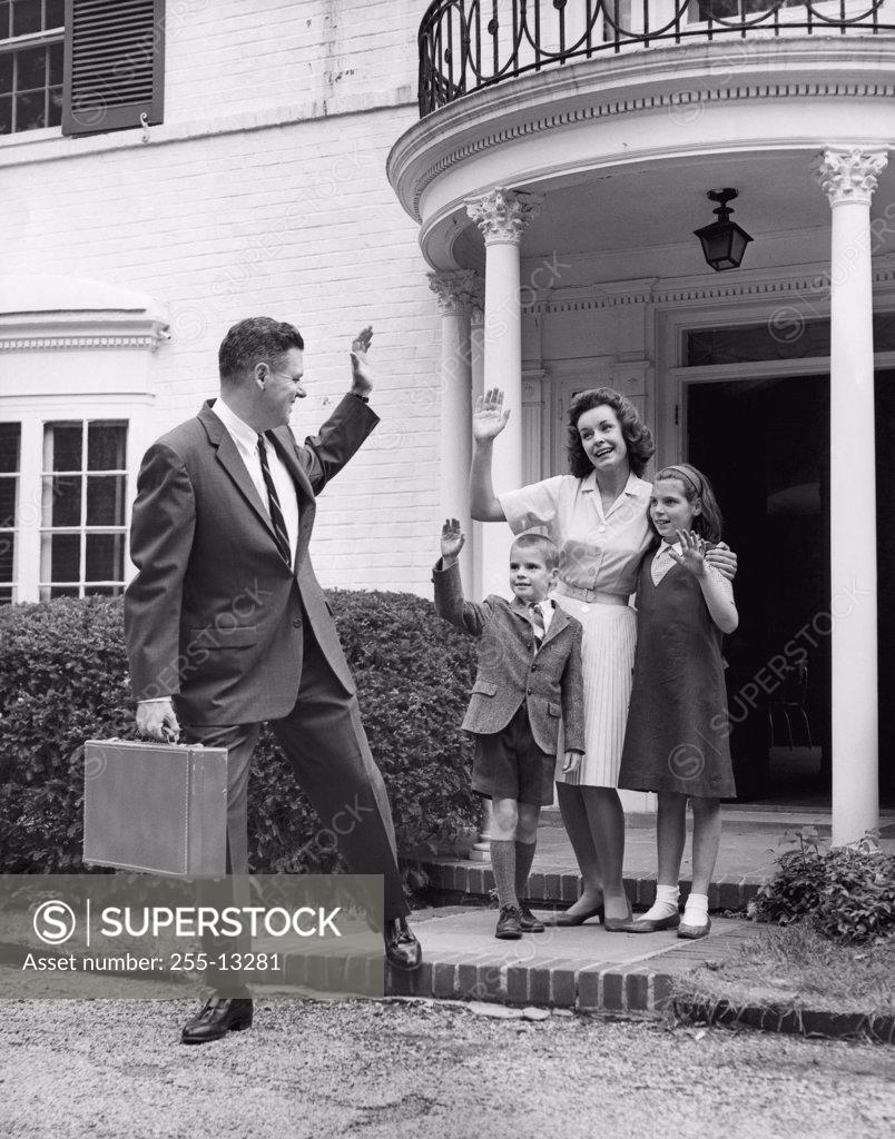 Stock Photo: 255-13281 Mature man waving at his wife and two children