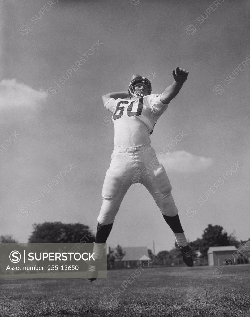 Stock Photo: 255-13650 Low angle view of a football player throwing a football