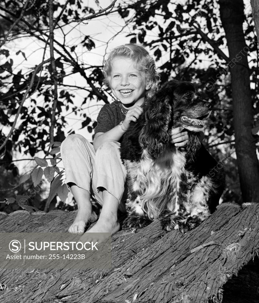 Stock Photo: 255-14223B Girl with dog sitting on shed roof