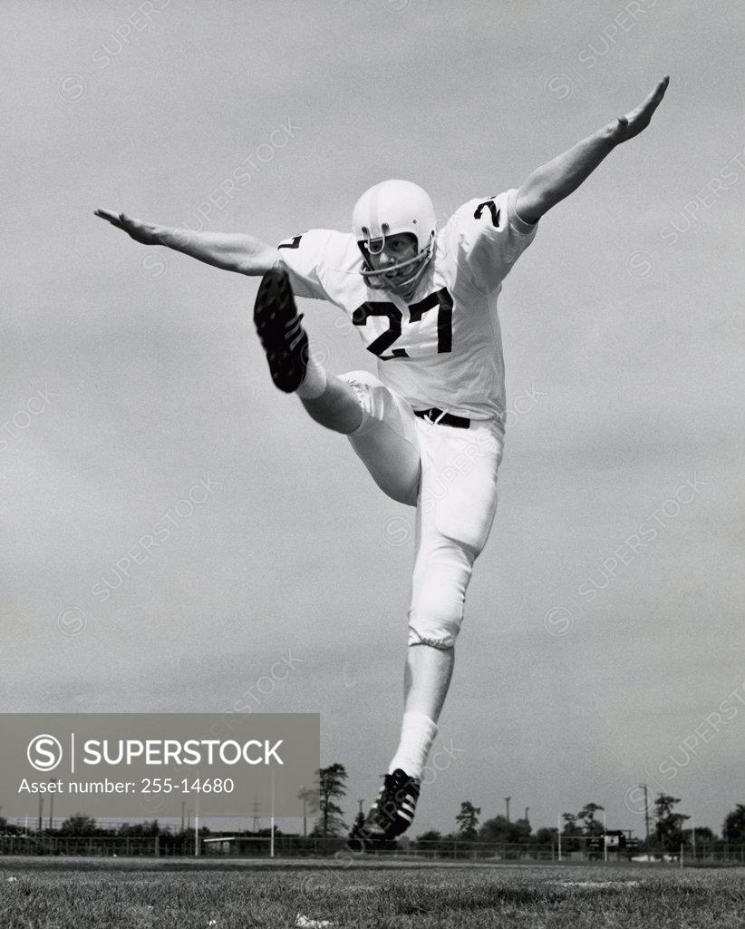 Stock Photo: 255-14680 Low angle view of a football player kicking