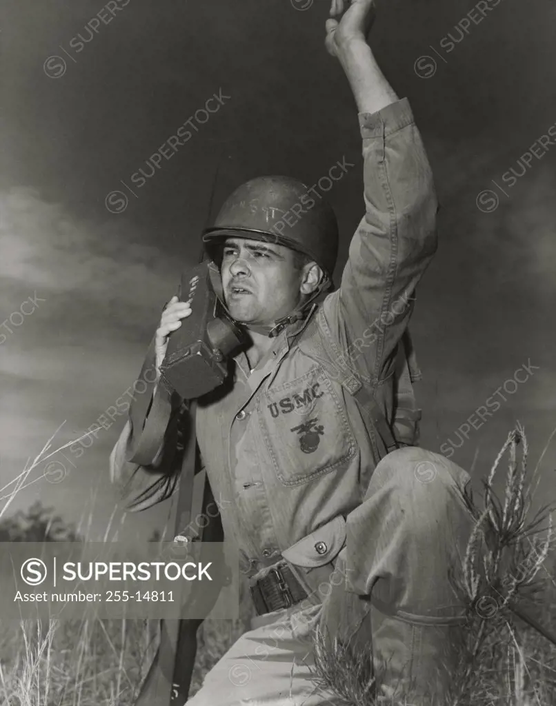 Soldier talking on a walkie-talkie during war