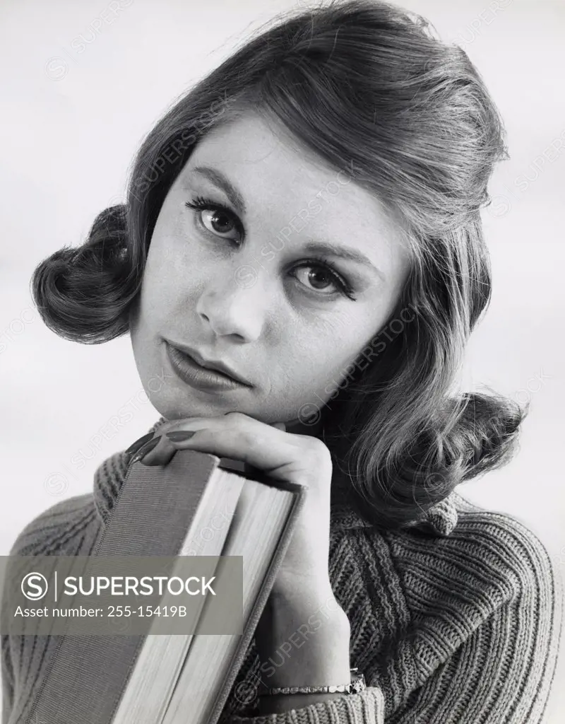 Portrait of a teenage girl holding a book