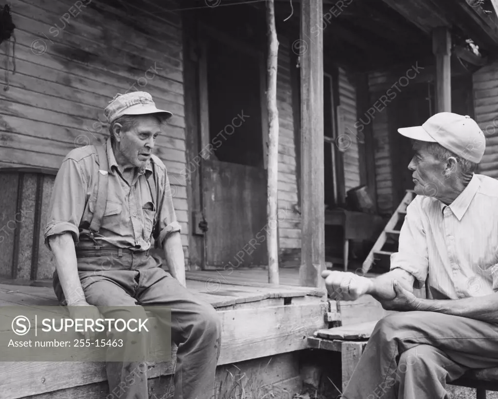 Two senior men talking to each other, Great Depression, USA, 1930s