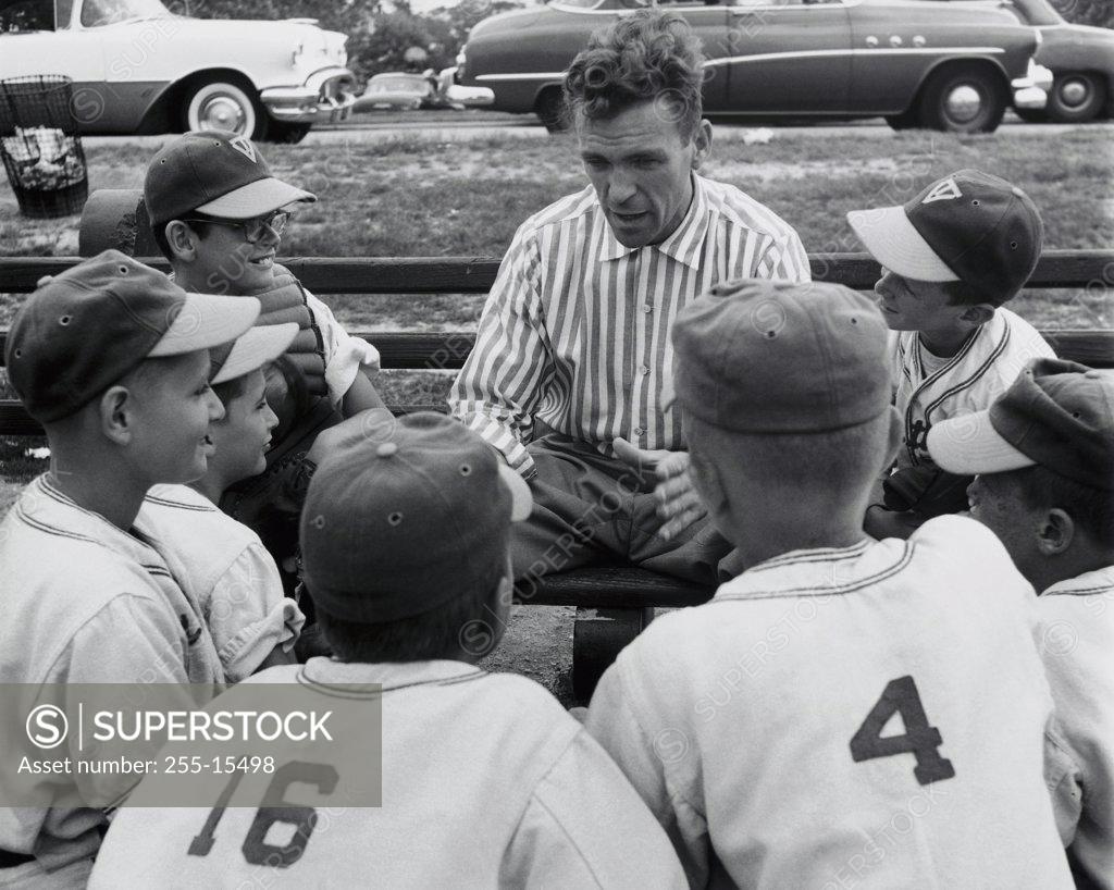 Stock Photo: 255-15498 Players of a youth league baseball team with their coach
