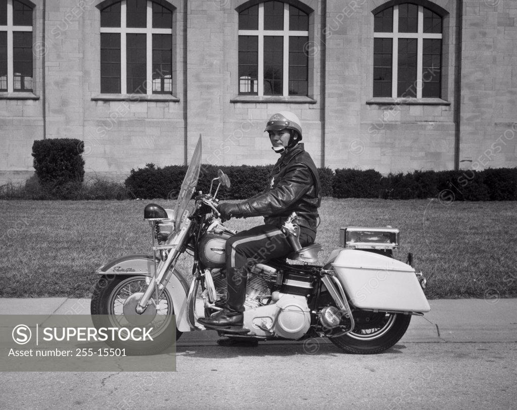 Stock Photo: 255-15501 Side profile of a policeman riding a motorcycle