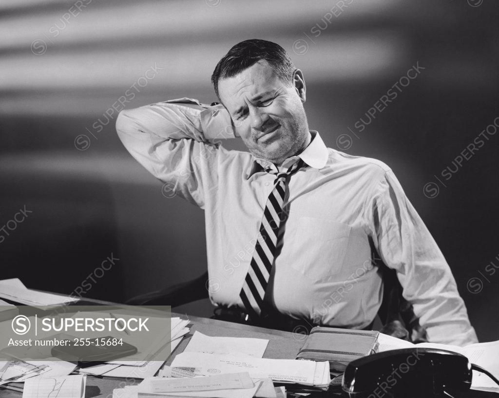Stock Photo: 255-15684 Businessman stretching in an office
