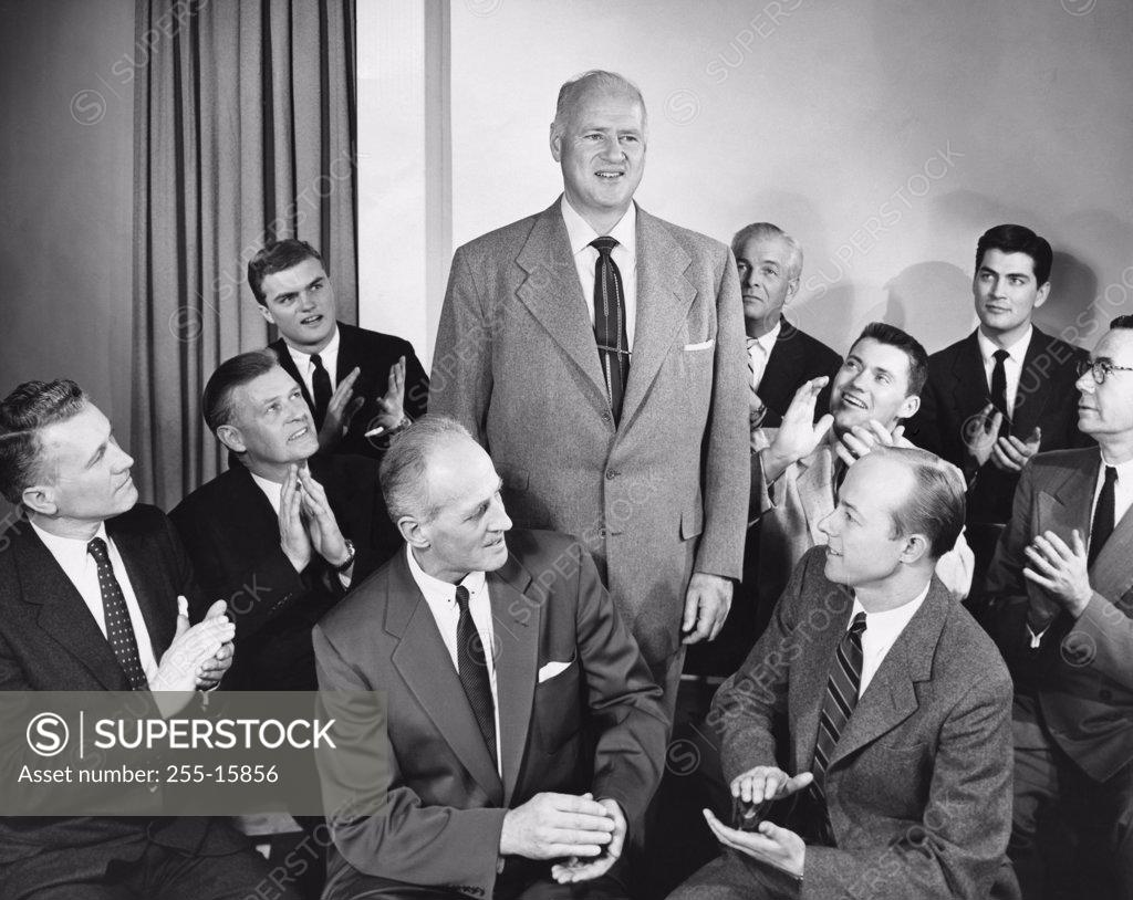 Stock Photo: 255-15856 Group of businessmen applauding their colleague