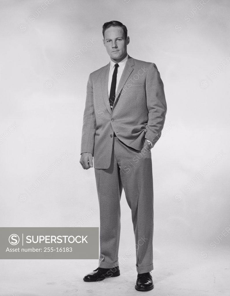 Stock Photo: 255-16183 Portrait of a businessman standing with one hand in his pocket
