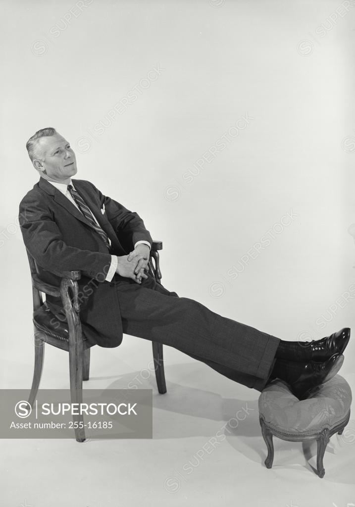 Stock Photo: 255-16185 High angle view of a businessman resting on an armchair