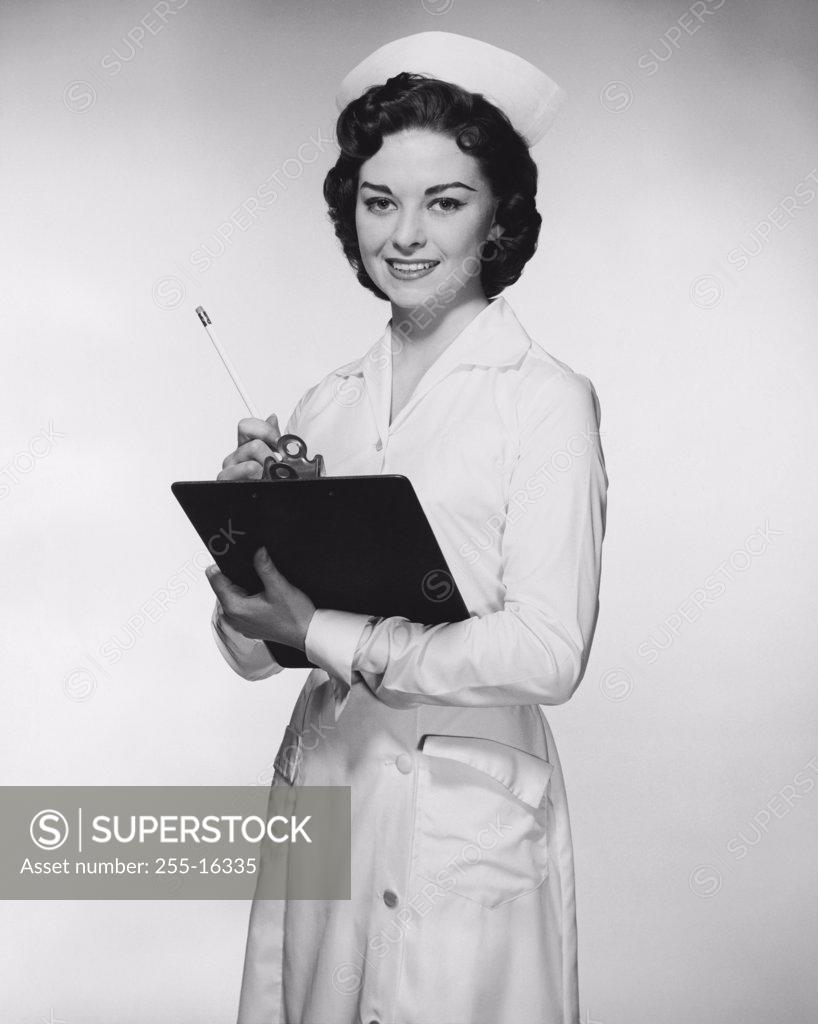 Stock Photo: 255-16335 Portrait of a female nurse holding a clipboard