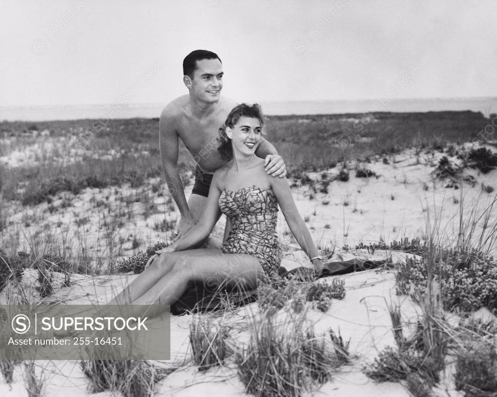 Stock Photo: 255-16451 Young couple sitting on beach