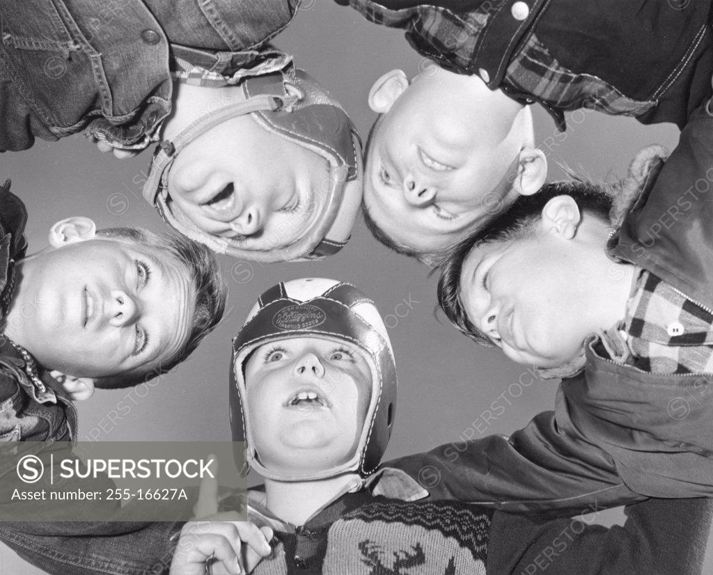 Stock Photo: 255-16627A Low angle view of five football players in a huddle