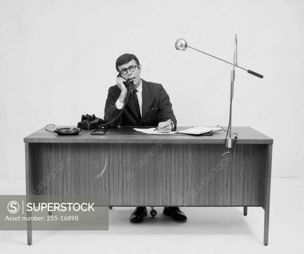 Stock Photo: 255-16898 Businessman talking on the telephone in an office
