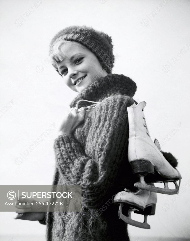 Stock Photo: 255-17272B Portrait of a teenage girl carrying a pair of ice skates